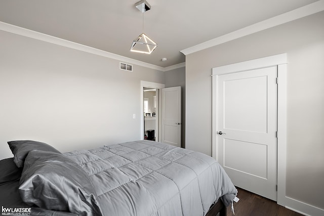 bedroom with visible vents, crown molding, and dark wood-type flooring