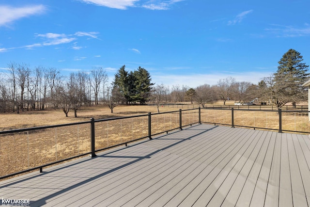 deck featuring a rural view and fence