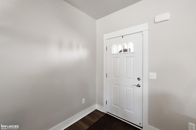 entryway with baseboards and dark wood-style flooring