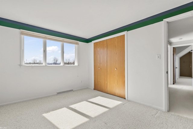 unfurnished bedroom with a closet, visible vents, carpet flooring, and baseboards