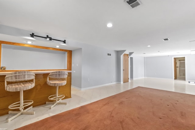 spare room with recessed lighting, light colored carpet, and visible vents