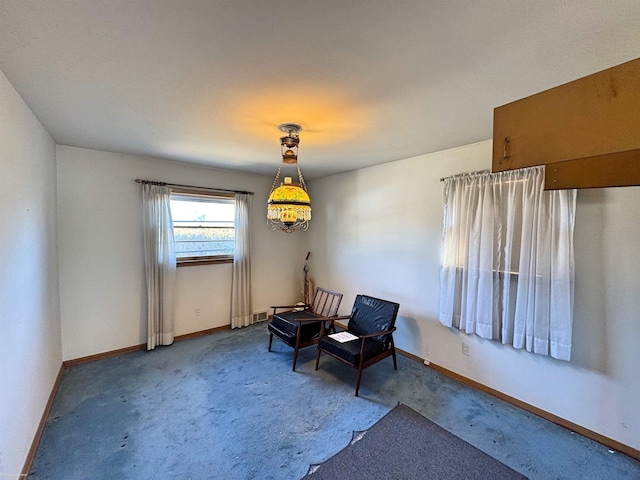 sitting room with carpet flooring and baseboards