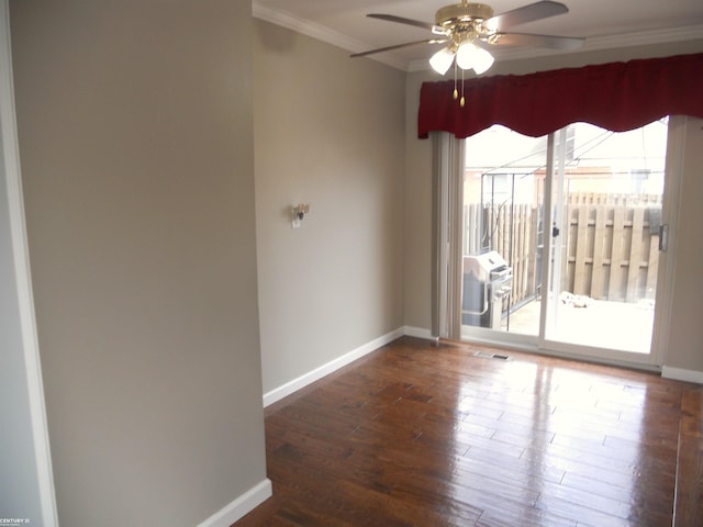 unfurnished room with baseboards, crown molding, ceiling fan, and wood finished floors