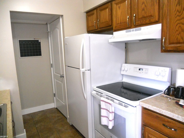 kitchen featuring dark tile patterned floors, under cabinet range hood, white electric stove, brown cabinetry, and light countertops