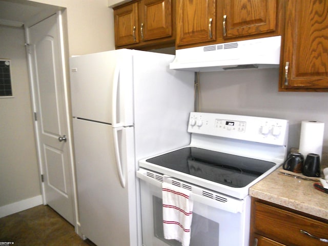 kitchen featuring white appliances, baseboards, light countertops, under cabinet range hood, and brown cabinets