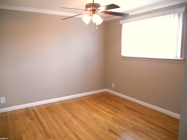 empty room with light wood-type flooring, baseboards, ceiling fan, and crown molding