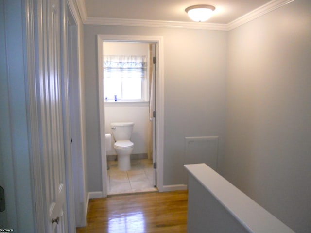 bathroom with crown molding, toilet, and wood finished floors