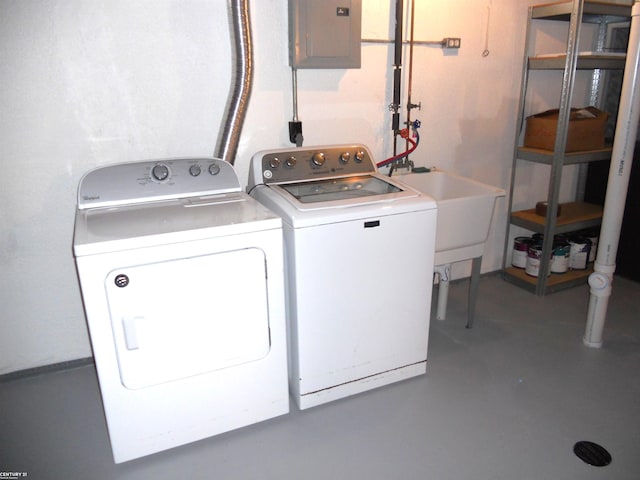 washroom featuring laundry area, electric panel, separate washer and dryer, and a sink