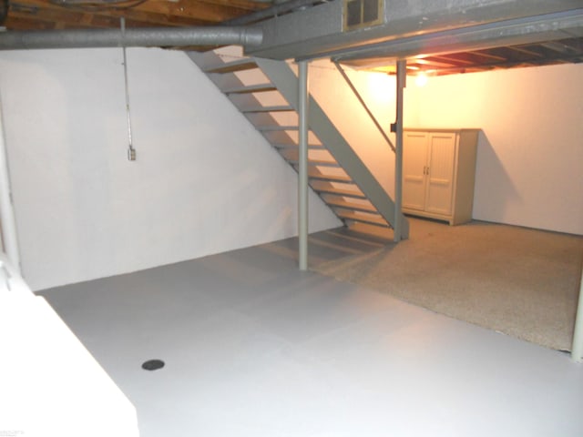 unfinished below grade area with stairs and visible vents