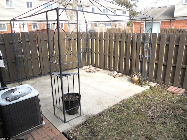 view of patio with central AC and fence