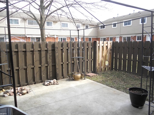 view of patio / terrace with a residential view and fence