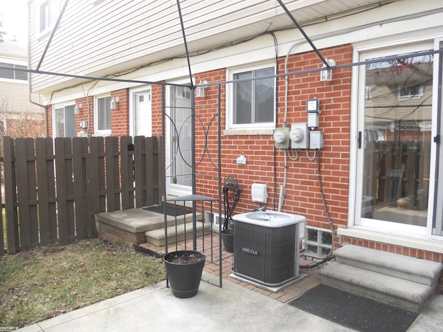 view of patio featuring cooling unit and fence