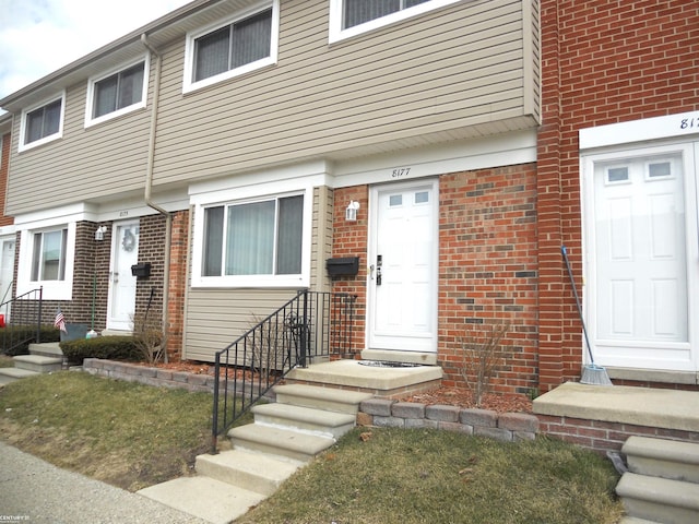 view of exterior entry with brick siding