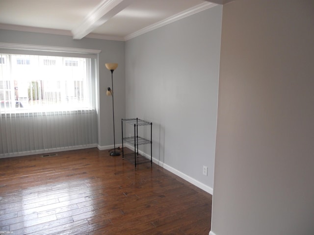 spare room with beamed ceiling, baseboards, wood-type flooring, and ornamental molding