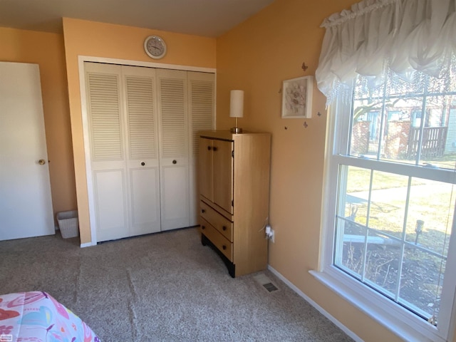 unfurnished bedroom featuring visible vents, a closet, and carpet flooring