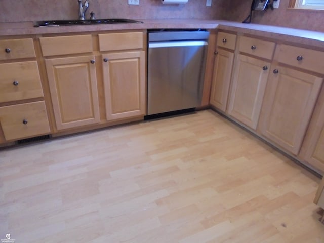 kitchen with backsplash, light brown cabinets, dishwasher, light wood-style flooring, and a sink