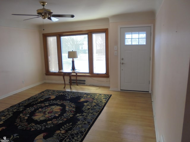 foyer featuring light wood-type flooring, a wealth of natural light, and ceiling fan