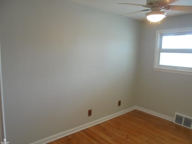 empty room featuring visible vents, baseboards, light wood-style floors, and a ceiling fan