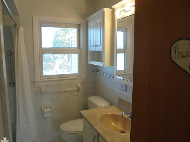 full bathroom with curtained shower, toilet, tile walls, and vanity