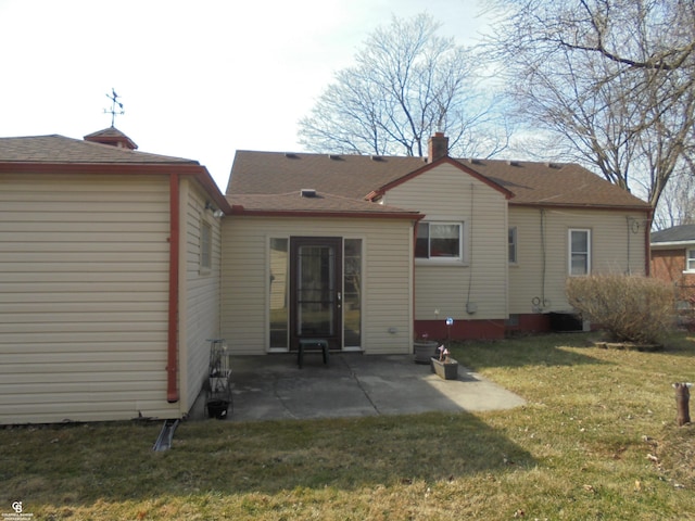 back of house featuring a lawn and a patio