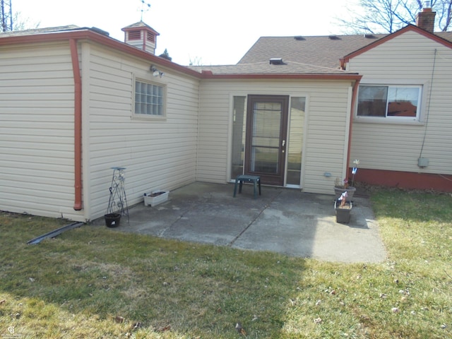 back of house featuring a patio and a lawn