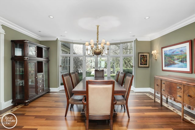 dining area featuring wood finished floors, an inviting chandelier, and ornamental molding