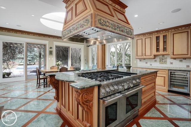 kitchen with range with two ovens, recessed lighting, custom range hood, wine cooler, and backsplash