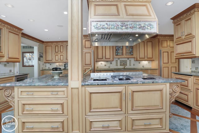 kitchen featuring custom exhaust hood, stainless steel gas stovetop, glass insert cabinets, and backsplash