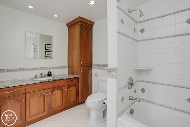 full bathroom featuring vanity, shower / bathing tub combination, wainscoting, tile walls, and toilet