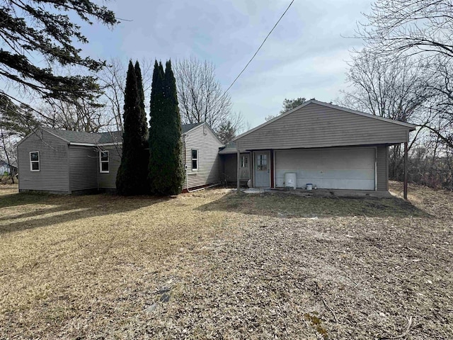 back of house with an attached garage