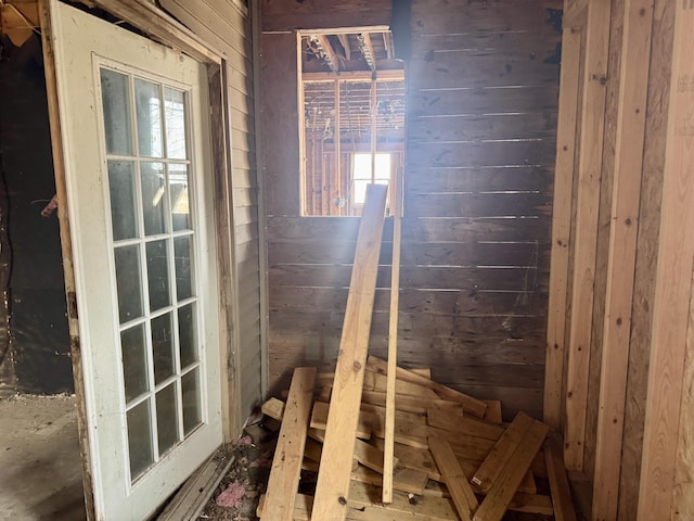 basement featuring wood walls