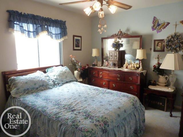 carpeted bedroom with a ceiling fan