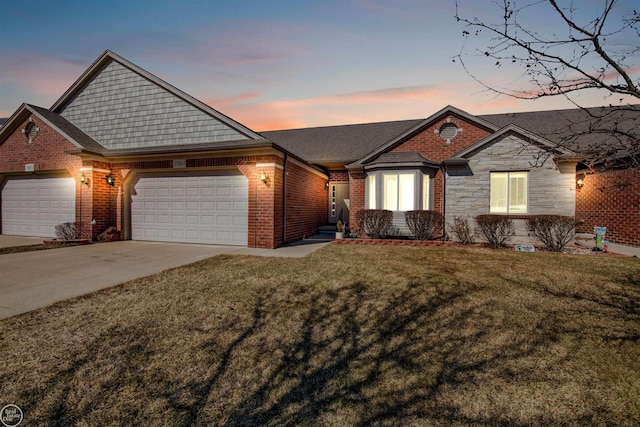 single story home with a front lawn, an attached garage, brick siding, and concrete driveway