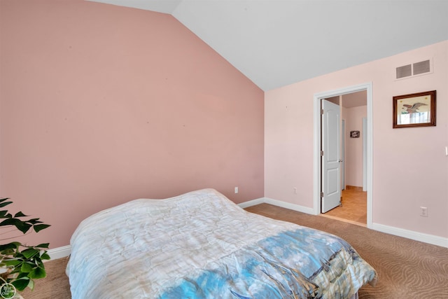 carpeted bedroom featuring visible vents, baseboards, and lofted ceiling