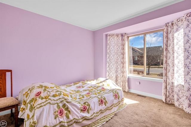 bedroom featuring visible vents, carpet flooring, and baseboards