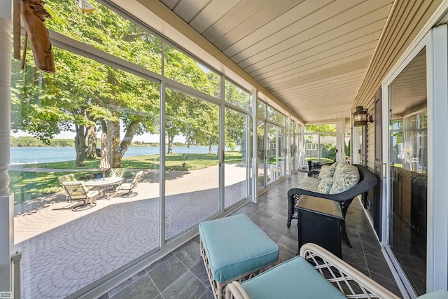 sunroom with a water view and wooden ceiling