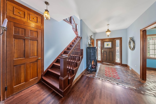 entrance foyer with stairs, baseboards, and wood finished floors