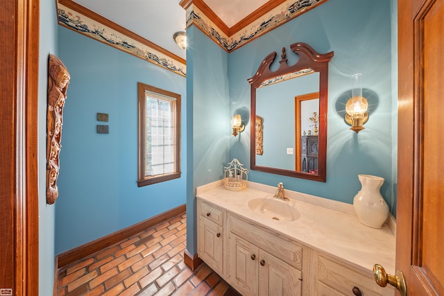 bathroom with vanity, brick floor, and baseboards