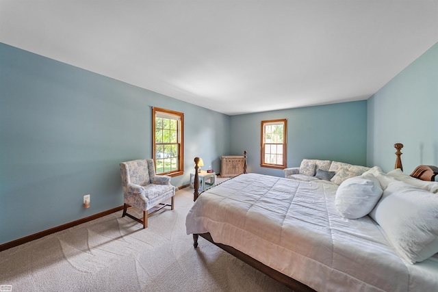 bedroom featuring carpet flooring, multiple windows, and baseboards