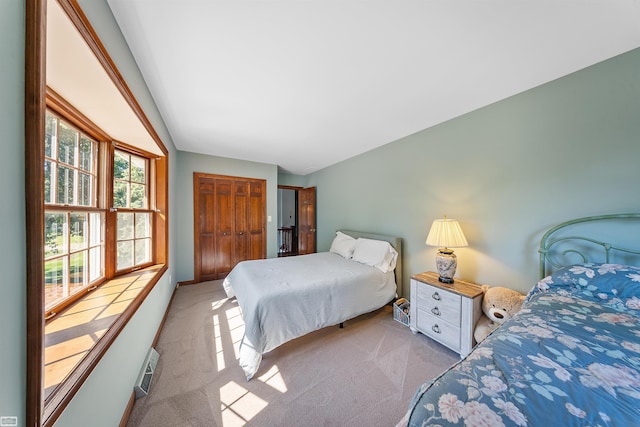 carpeted bedroom featuring a closet