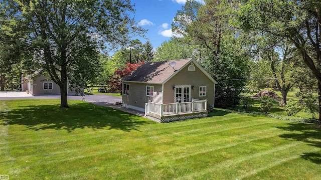 exterior space with a deck and a front lawn