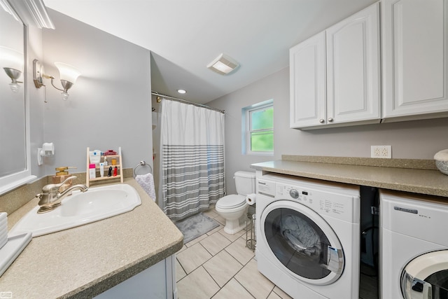 interior space featuring tile patterned floors, visible vents, toilet, separate washer and dryer, and vanity