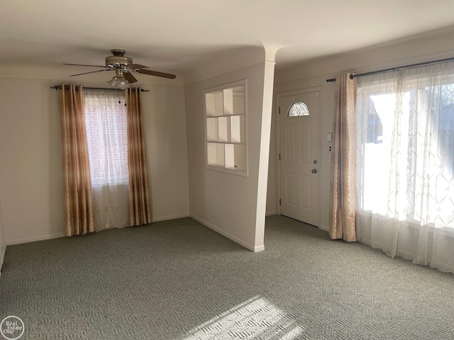 entrance foyer featuring plenty of natural light, carpet, baseboards, and ceiling fan