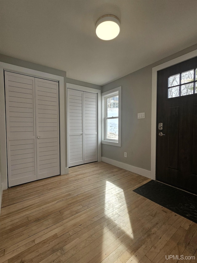 entrance foyer featuring light wood-style flooring and baseboards