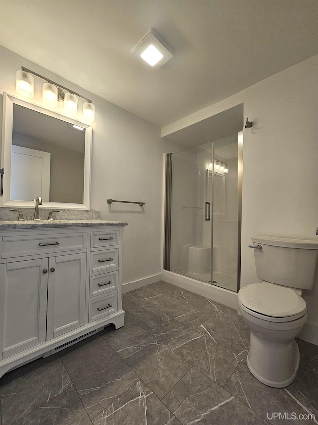 full bath with toilet, marble finish floor, a shower stall, baseboards, and vanity