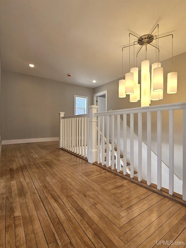 hall featuring recessed lighting, baseboards, and hardwood / wood-style floors