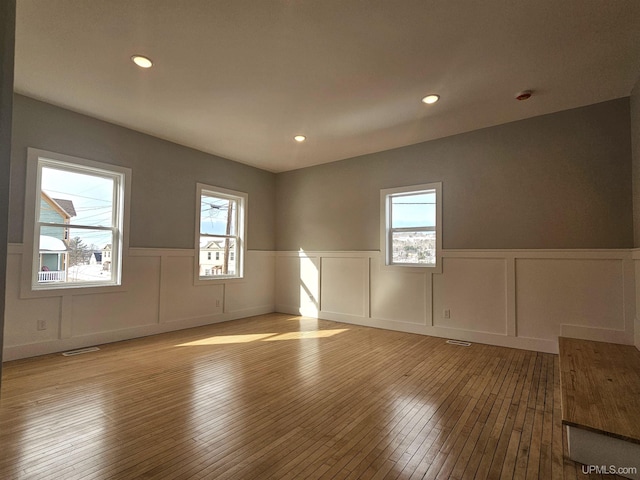 unfurnished room with recessed lighting, visible vents, a healthy amount of sunlight, and light wood finished floors