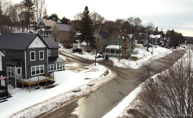 snowy aerial view featuring a residential view