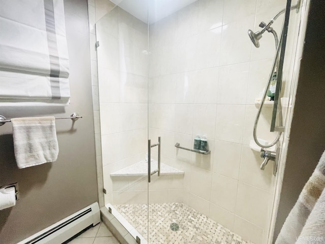 full bathroom featuring tile patterned floors, a baseboard radiator, and a shower stall