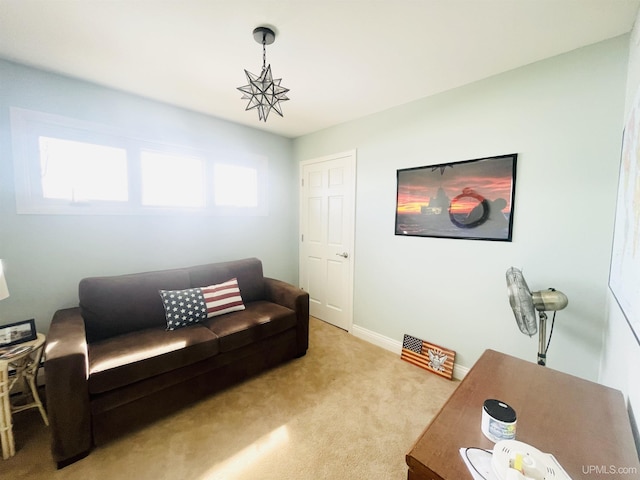 living room featuring baseboards and light carpet